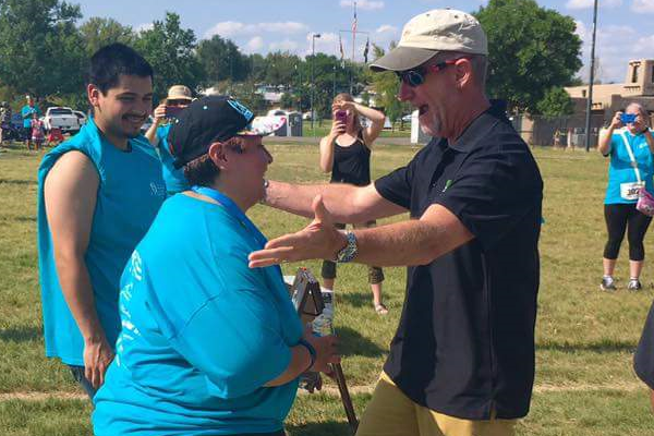 Marie Apodaca congratulates CA Walk Advocate Award Winner, Dennis Schlaht